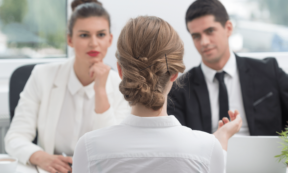woman sitting in interview with 2 hiring managers