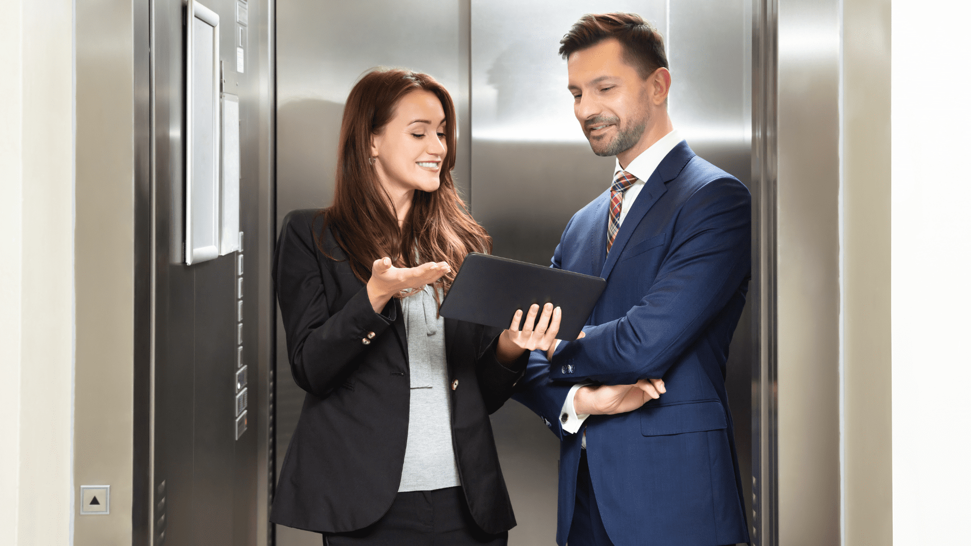 Two people discussing options in an elevator
