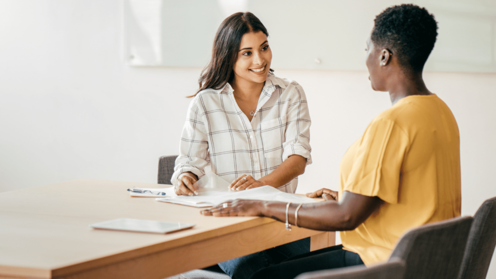 Two women reviewing a report