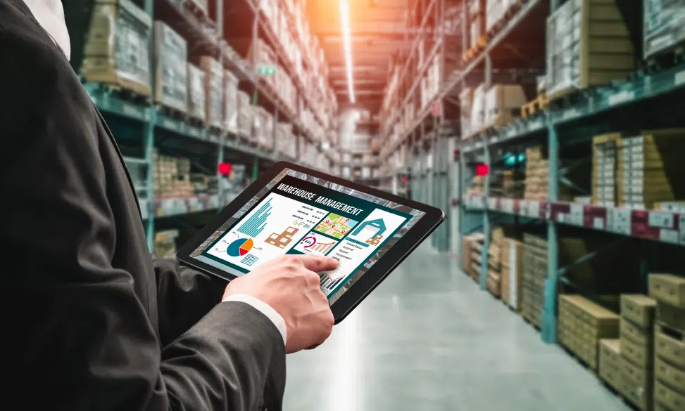 man holding tablet in distribution warehouse