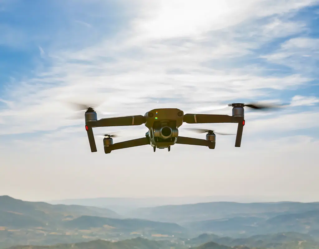 A drone flying over a landscape, showcasing advanced drone technology used for environmental inspections.