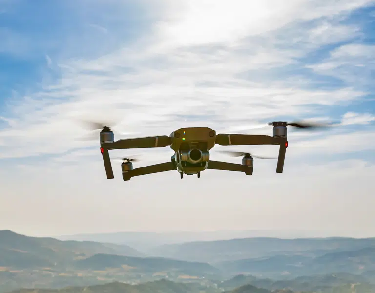 A drone flying over a landscape, showcasing advanced drone technology used for environmental inspections.