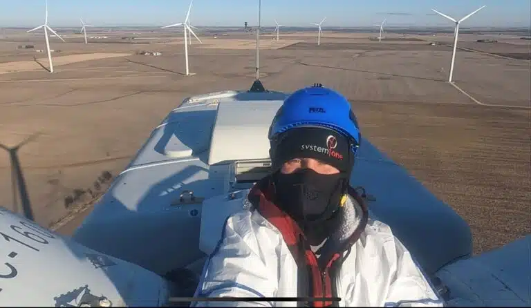 Engineer taking selfie on top of wind turbine